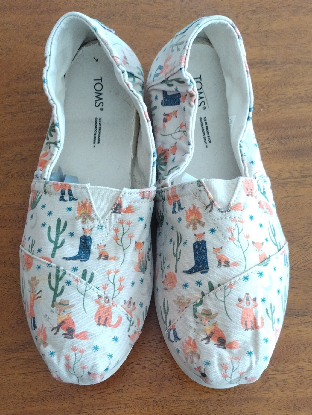 TOMS Cream Canvas Slip-Ons with Cowboy Dessert Motif Print